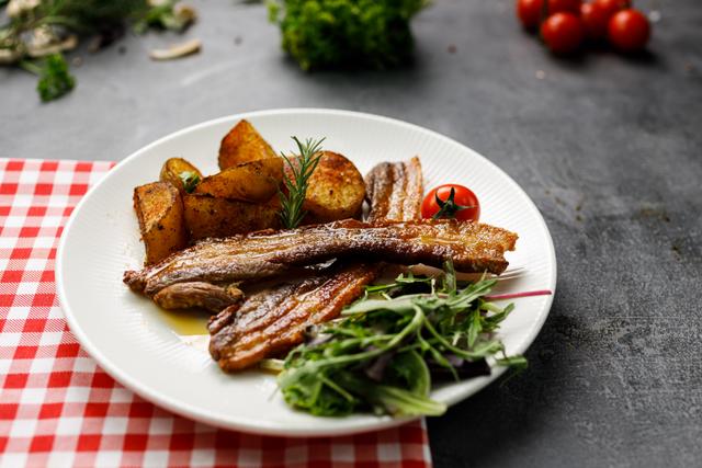 Crispy Rib Ensemble with Roasted Potatoes and Vibrant Greens